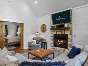 a living room with couches and a fireplace at Stunning Luxury Cabin w Hot Tub and Fire Pit Holy Shiplap is Perfect Romantic Couples Getaway in Broken Bow