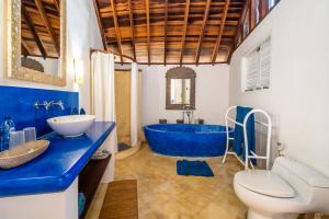 a blue bathroom with a tub and a sink at Villa Nirvana Biru Bingin Beach in Uluwatu +31 photos