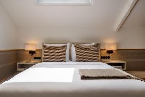 a bedroom with a large white bed with two pillows at Casa da Marechal - Boutique Hotel by Oporto Collection - Adults Only in Porto