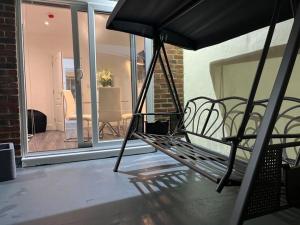 a hammock sitting on a balcony in a house at Spacious & Modern CENTRAL 1 bed Apartment with OUTSIDE space in Watford