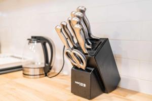 a knife block with utensils in it on a counter at Newly Remodeled 2B1B House on Historic Route 66 in Glendora