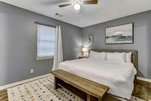 a bedroom with a large white bed and a window at Wilmington Island Retreat in Savannah