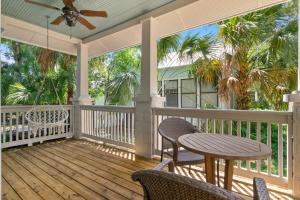 a porch with chairs and a table and a ceiling fan at Oneida Charmed - Historic Cottage w Modern Flair in Saint Augustine