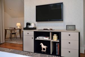 a entertainment unit with a tv on a wall at Casa da Marechal - Boutique Hotel by Oporto Collection - Adults Only in Porto