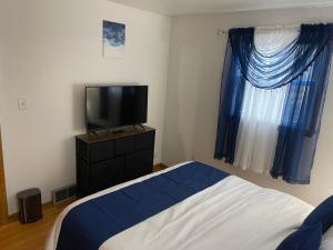 a bedroom with a bed and a flat screen tv at Elite Casa Collection -free coffee, parking, and Wi-Fi in Milwaukee