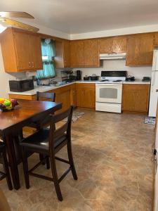 a kitchen with wooden cabinets and a table and a stove at Elite Casa Collection -free coffee, parking, and Wi-Fi in Milwaukee