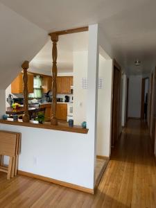 a kitchen with white walls and a wooden floor at Elite Casa Collection -free coffee, parking, and Wi-Fi in Milwaukee +10 photos