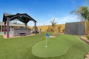 einen Minigolfplatz im Hinterhof mit Pavillon in der Unterkunft Buddha Mansion Luxury Resort - 8BR Modern, HotTub, Huge pool, Sauna, BBQ grill, Game Room in Las Vegas