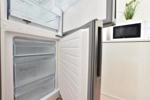 een koelkast met een open deur in een keuken bij Big Wilten Apartment with free parking- Central and Peaceful in Innsbruck