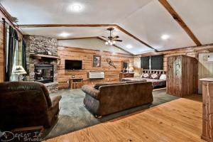 a living room with a couch and a fireplace at Secluded 2 story cabin Pool WiFi smart TVs in Eureka Springs
