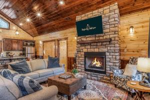 a living room with a stone fireplace in a cabin at Large Luxury 2BR Cabin w Hot Tub Double Trouble was designed for fun comfort and memories minutes from buzzling Hochatown and beautiful Beaver Bend State Park in Broken Bow