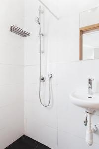 a white bathroom with a shower and a sink at Beautiful Studio in Flea Market By Holiday Rentals in Tel Aviv