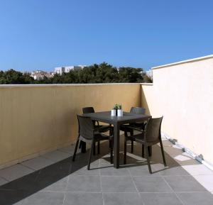 a black table and chairs on a balcony at Beautiful Studio in Flea Market By Holiday Rentals in Tel Aviv