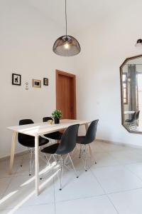 a dining room table with chairs and a mirror at Flea Market 1BR - 30 09 Olei Zion St Tel Aviv in Tel Aviv