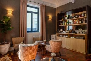 a bar with chairs and a table in a room at Casa da Marechal - Boutique Hotel by Oporto Collection - Adults Only in Porto