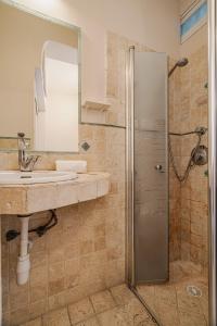 a bathroom with a sink and a shower with a mirror at 2BR - 2 12 Hei be-Iyar St Tel aviv in Tel Aviv