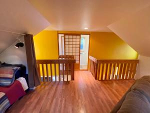 a living room with yellow walls and a couch at Quiet, Elegant & Cozy - 4 Miles from Downtown in Talkeetna