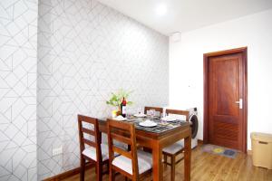 a dining room with a table and chairs at QMP Friendly House PKB in Hanoi