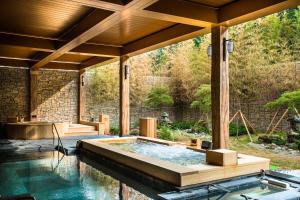an outdoor pool with a hot tub in a house at Sono Belle Cheongsong in Cheongsong