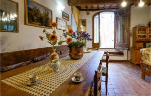 een eettafel met twee kopjes en bloemen erop bij 4 Bedroom Lovely Home In Cetona in Cetona