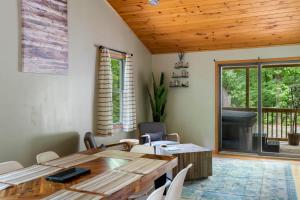 a dining room with a wooden table and chairs at Modern Cabin w Hot Tub Fire Pit WiFi in Berkeley Springs