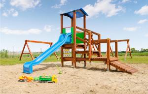 a playground with a slide in the sand at Nice Home In Jaroslawiec With Kitchen in Jarosławiec