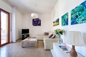 a living room with a couch and a table at Di Palma 4 Family House - Lecce Selection in Lecce +31 photos
