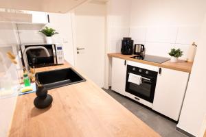 a kitchen with a counter top with a microwave at Hamburg City Apartment for 5 in Hamburg