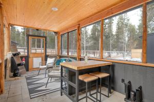 a screened in porch with a table and chairs at Bend Retreat in Bend