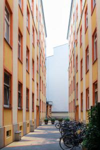 a row of bikes parked next to tall buildings at Rosenthaler Calling - Rooftop Apartment in Berlin +7 photos
