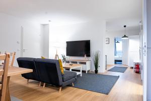 a living room with a couch and a tv at 122 Luruper 2 in Hamburg