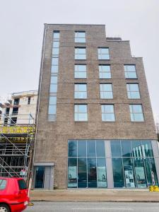 a tall brick building with a red van parked in front at 122 Luruper 2 in Hamburg