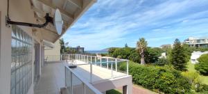 a balcony with a view of the ocean at Villa Azure - Sea Views, Pool - 70m onto Robberg 5 Beach in Plettenberg Bay