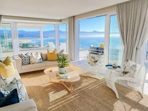 a living room with a view of the ocean at Dizzy Hill Villa with 270° Breathtaking Views. Pool + Patio in Plettenberg Bay