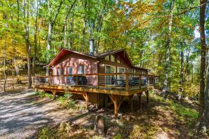a log cabin in the woods with trees at Hot Tub, Big Deck, Comm Pool, WiFi at Chalet Cabin in Berkeley Springs