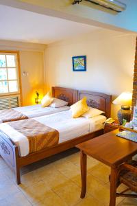מיטה או מיטות בחדר ב-Hotel Deli River and Restaurant Omlandia