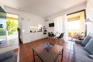 a living room with a couch and a table at Barbati Bay Suite in Barbati