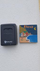 a dvd player sitting on a wall next to a card at Bilocale Elena 40mq in Conca dei Marini