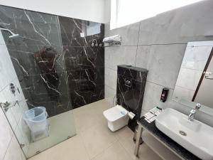 a bathroom with a sink and a shower and a toilet at Click Collection The Abode, Dharamshala in Dharamshala