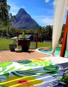 a blanket on a deck with a view of a mountain at Sunshine Coast Farm Stay in Glass House Mountains