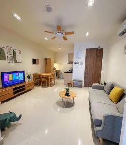 a living room with a couch and a flat screen tv at THE SHORE SEAVIEW Centre Of The City in Kota Kinabalu