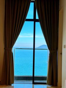 a view of the ocean from a window at THE SHORE SEAVIEW Centre Of The City in Kota Kinabalu