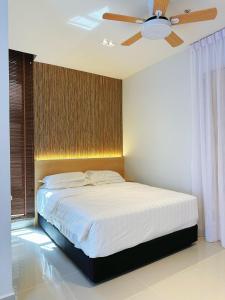 a bedroom with a bed with a ceiling fan at THE SHORE SEAVIEW Centre Of The City in Kota Kinabalu