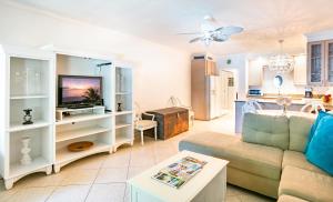 a living room with a couch and a tv at Beach Living at Island Pine Villas (BLV) in George Town