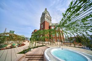 a building with a clock tower and a swimming pool at ROYAL CHESTER NAGASAKI hotel&retreat in Nagasaki