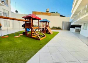 a playground with two swings and a slide at Depa M&M in Guadalajara