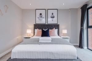 a bedroom with a large bed with two lamps at Host & Stay - Duke Street Living in Liverpool