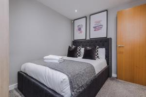a bedroom with a large bed with black and white pillows at Host & Stay - Duke Street Living in Liverpool