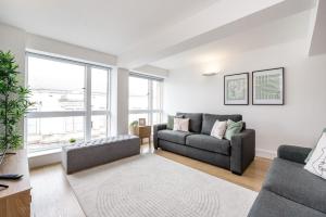 a living room with two couches and a large window at Host & Stay - The Cavern Quarter Apartment in Liverpool