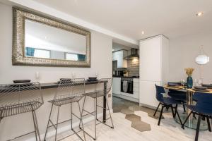 a kitchen and dining room with a mirror on the wall at Host & Stay - City Centre Duplex Apartment in Liverpool